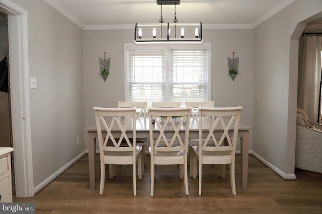 dining room with ornamental molding and dark hardwood / wood-style floors