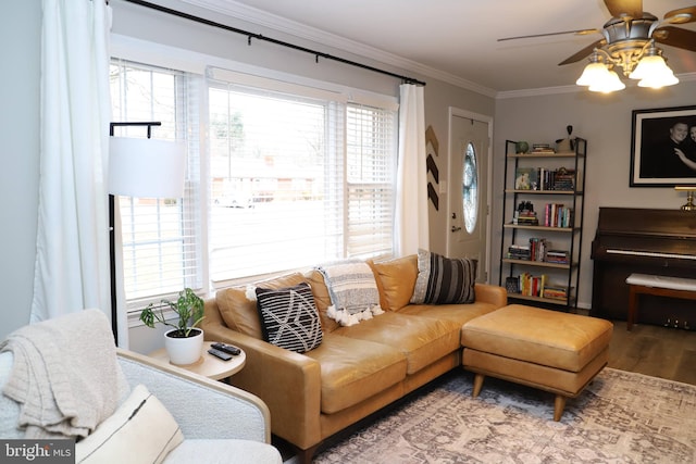 living room with hardwood / wood-style flooring, ceiling fan, ornamental molding, and a wealth of natural light