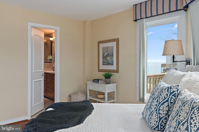 bedroom with baseboards and wood finished floors