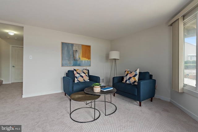 living area featuring carpet floors and baseboards