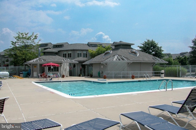 pool featuring a patio and fence