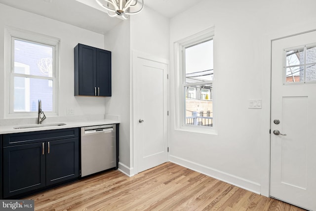 kitchen with sink, a notable chandelier, dishwasher, and light wood-type flooring