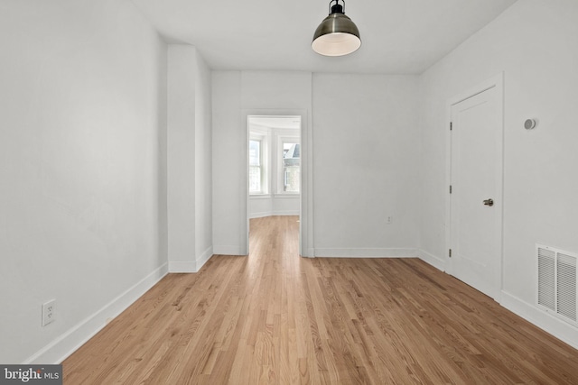 unfurnished room with light wood-type flooring