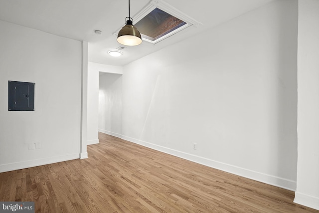 unfurnished dining area featuring electric panel and light hardwood / wood-style flooring