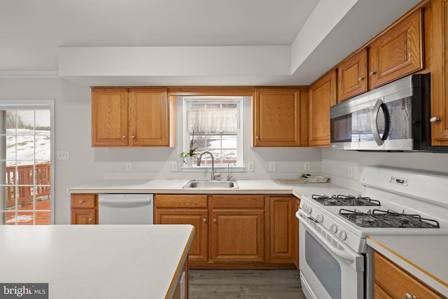 kitchen with sink, white appliances, and light wood-type flooring