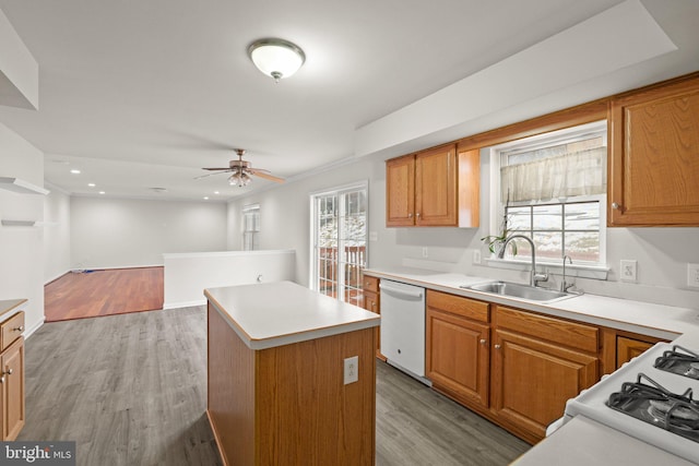 kitchen featuring a kitchen island, sink, ceiling fan, white dishwasher, and light hardwood / wood-style floors