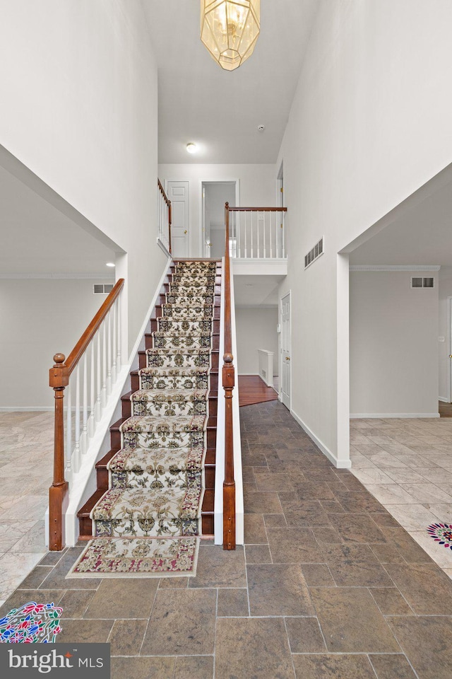 stairway featuring a high ceiling