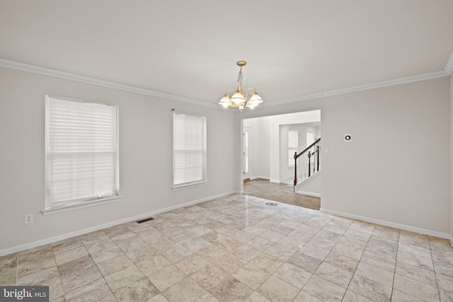 empty room featuring an inviting chandelier and crown molding