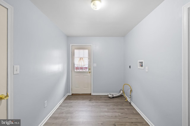 laundry area with hookup for a washing machine, electric dryer hookup, and light hardwood / wood-style flooring