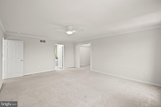 carpeted spare room featuring ornamental molding and ceiling fan