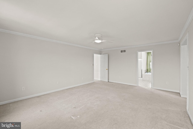 carpeted spare room with ceiling fan and ornamental molding