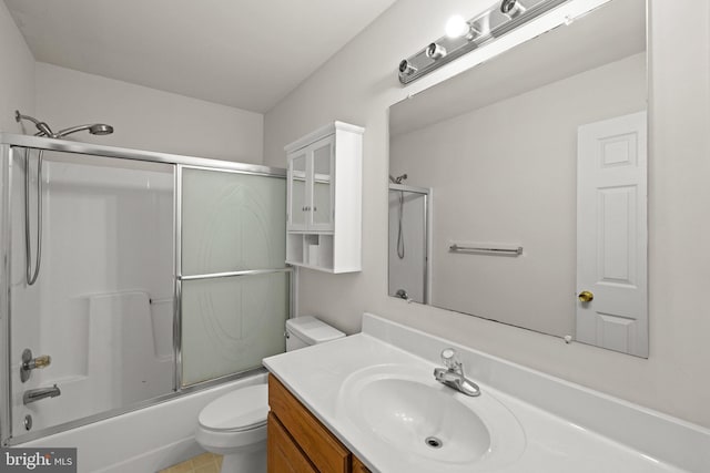 full bathroom featuring vanity, shower / bath combination with glass door, and toilet