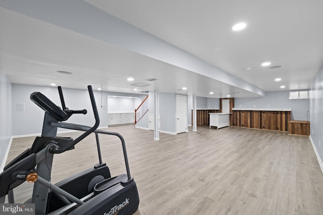 exercise area with bar area and light wood-type flooring