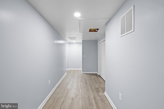 corridor with light hardwood / wood-style flooring