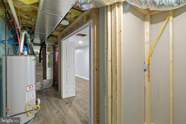 utility room with heating unit and water heater