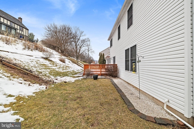 yard layered in snow featuring a wooden deck