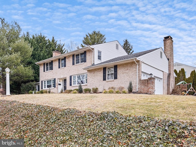 view of front of home with a garage and a front yard