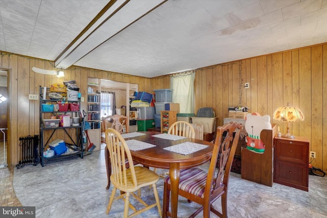 dining room featuring wood walls