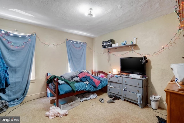 carpeted bedroom featuring a textured ceiling