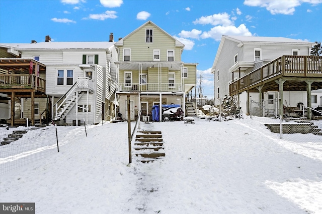 view of snow covered rear of property