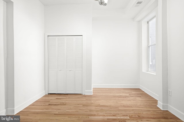 unfurnished bedroom with light hardwood / wood-style floors and a closet