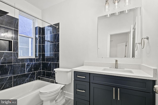 full bathroom with vanity, tiled shower / bath combo, and toilet