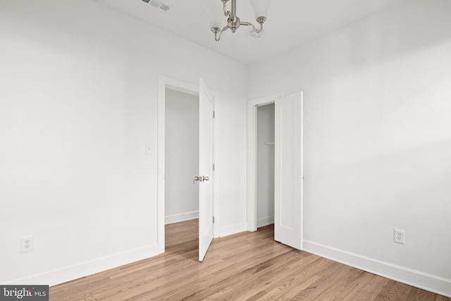 unfurnished bedroom featuring a closet and light wood-type flooring