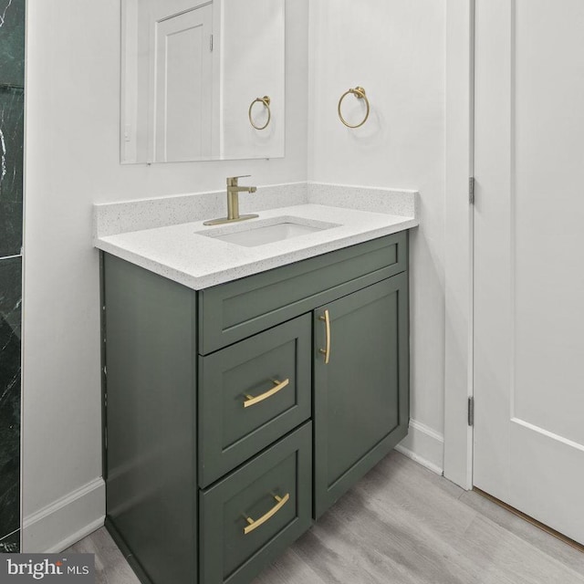 bathroom with vanity and hardwood / wood-style floors