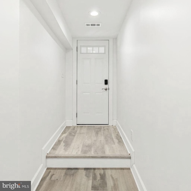 doorway to outside with wood-type flooring