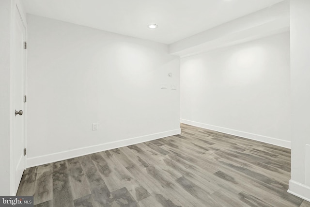 unfurnished room with hardwood / wood-style flooring