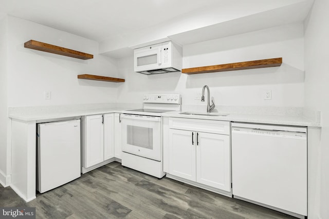 kitchen with sink, white appliances, dark hardwood / wood-style floors, and white cabinets