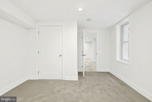 unfurnished bedroom with light colored carpet