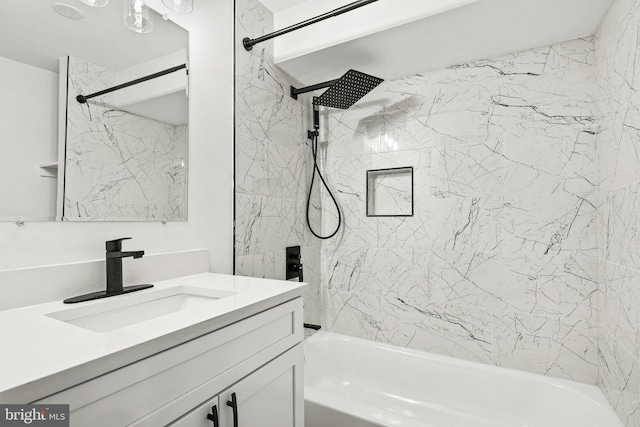 bathroom featuring tiled shower / bath combo and vanity