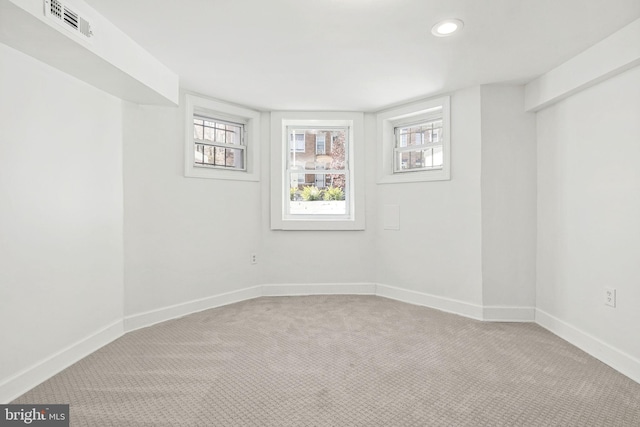 carpeted empty room with plenty of natural light