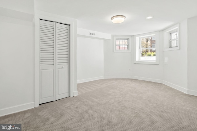 unfurnished bedroom featuring carpet floors and a closet