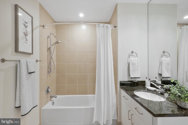 bathroom featuring vanity and shower / tub combo with curtain