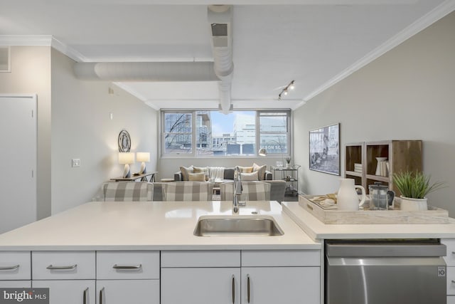 kitchen with ornamental molding, sink, stainless steel dishwasher, and white cabinets