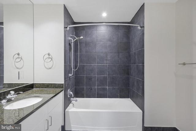 bathroom featuring vanity and tiled shower / bath combo