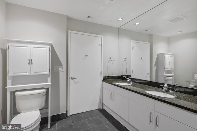 bathroom featuring vanity, tile patterned floors, and toilet