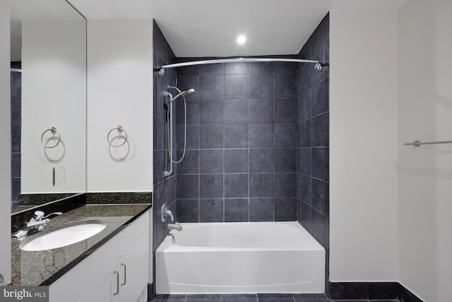 bathroom with vanity and tiled shower / bath combo