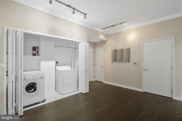 laundry area with crown molding, dark wood-type flooring, and independent washer and dryer