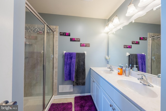 bathroom with vanity and a shower with shower door