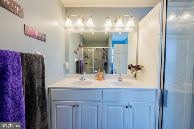 bathroom featuring vanity and a shower with door