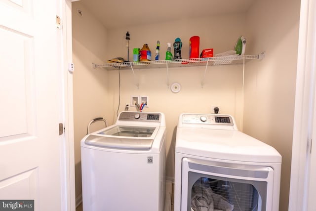 clothes washing area featuring washer and dryer