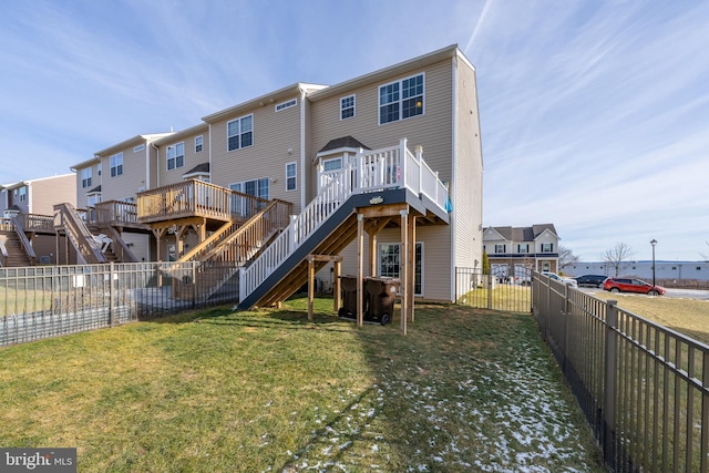 rear view of property featuring a wooden deck and a yard