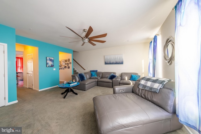 carpeted living room with ceiling fan