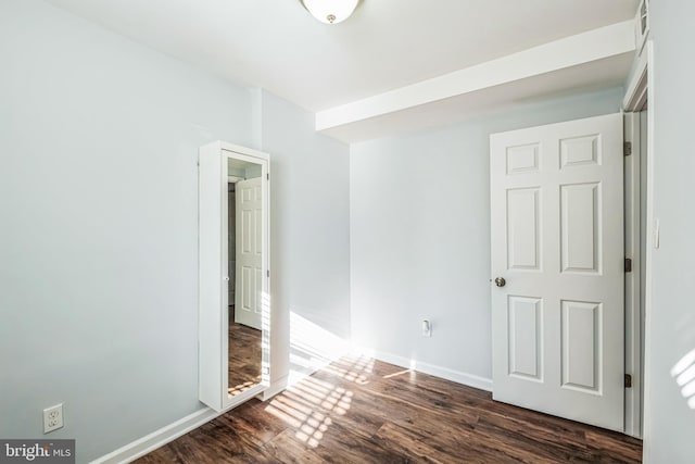 empty room with dark hardwood / wood-style floors