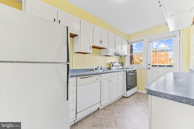 kitchen featuring sink, light tile patterned floors, white cabinets, and white appliances