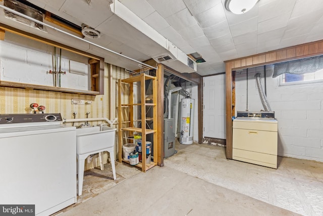 basement with gas water heater and washer / dryer