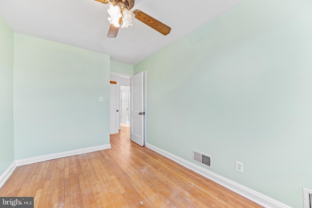 empty room with ceiling fan and light wood-type flooring